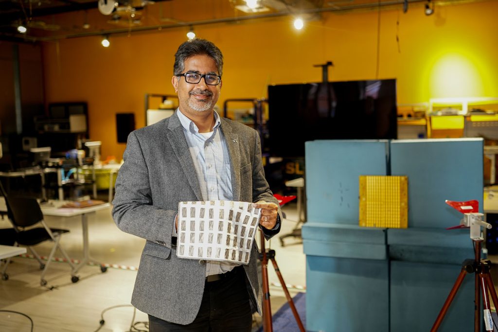 Professor Kapil Dandekar, PhD holds flexible fabric